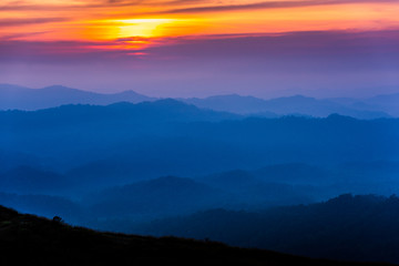 Fototapeta na wymiar layer mountains in the evening in the tropical rainforest of Thailand