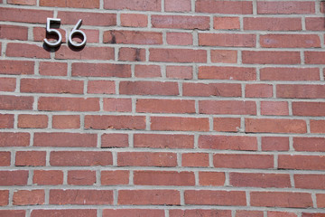 Fototapeta na wymiar brick wall with number 56