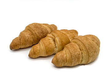 Three Crispy Brown Croissants on a white Background