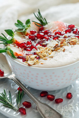 Healthy smoothie bowl of strawberries, pomegranate and almonds.
