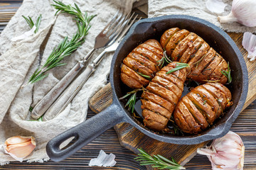 Frying pan with roasted potatoes and rosemary.