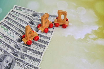 A lot of cash US dollars and wooden ABD letter