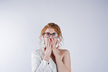 Curly hair girl astonished face in glasses isolated on white studio background.