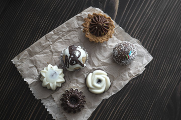 Different kinds of beautiful pastry, small colorful sweet cakes