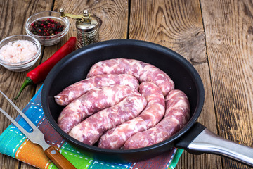 Sausage raw rustic in the pan