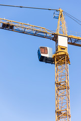 Naklejka premium High tower crane against the sky. Fragment of a crane