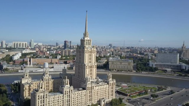 Aerial view of hotel Ukraine in Moscow. Old Soviet Russia Stalin high-rise skyscrapers in heart of modern Moscow City. Kutuzov avenue day traffic.