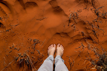 Woman feet in the red australian sand. Nothern Territory, Australia.
