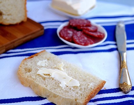 Sandwiches with sausage and butter on white wheat bread