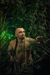a man in the jungle with machetes attacking the enemy