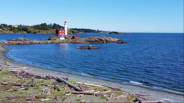 Fisgard Lighthouse National Historic Site with rolling waves along the Pacific coast near Victoria, BC, Canada