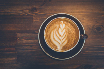 A cup of coffee on wooden surface