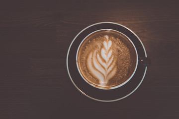 A cup of coffee on wooden surface