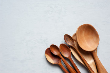 Wooden spoons of handmade different sizes close-up on the heap.