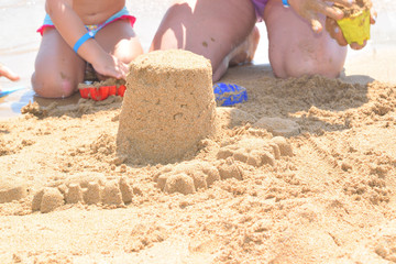 building a sand castle on the beach