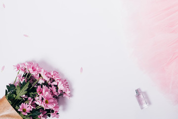 Top view of pink bouquet, petals, perfume