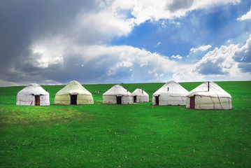 Yurts at Song Kol lake in Kyrgyzstan mountains.The turquoise sky, beautiful clouds,