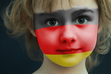 Child with a painted flag of Germany
