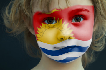 Child with a painted flag of Kiribati