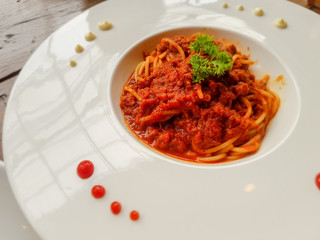 spaghetti meat or beef sauce in the big white dish. italian food.