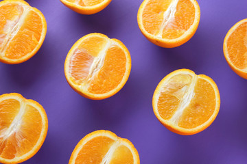 Sliced fruit oranges in checkered pattern on a purple background, symmetrically laid out citrus in pop art style, fruit pattern of halves of oranges, ultraviolet, minimalism, art