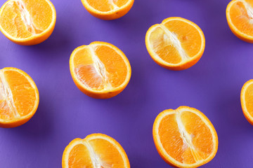Sliced fruit oranges in checkered pattern on a purple background, symmetrically laid out citrus in pop art style, fruit pattern of halves of oranges, ultraviolet, minimalism, art