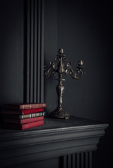 living room decor elemens: candlestick, fireplace and books