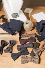 Close-up lots of ready made butterfly bow ties made of wool in the foreground, adds a finished product.