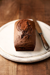 Simple Chocolate Cake. Baked homemade chocolate cake on wooden background. Vertical. 