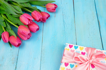 Bouquet of tulips on blue wooden table with gift box. Happy women's day. 8 March., Mother's Day. Flat lay and copy space