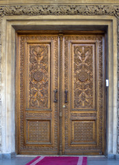Fototapeta na wymiar The church gate with a beautiful carving.