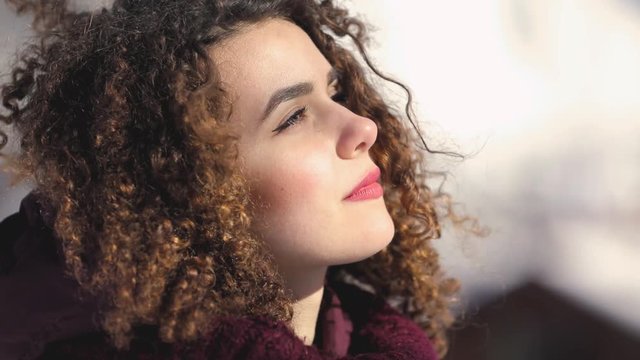 Slow motion, curly hair woman enjoys fresh cold air