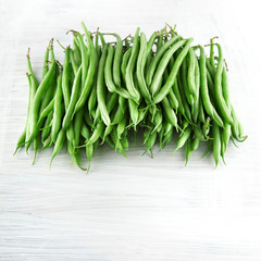 fresh green beans on white wooden kitchen plate, shabby chic, can be used as background