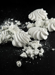 white meringues candy on black slate plate kitchen table can be used as background