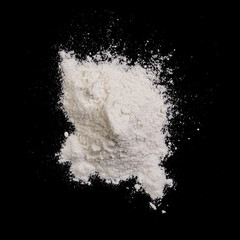 Obraz na płótnie Canvas wheat flour pile on black background