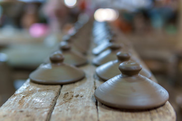selective focus. pile of unfinished handcraft pottery before put in the stove for make ceramic houseware, vintage style.