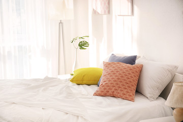 Stylish interior of room with comfortable bed