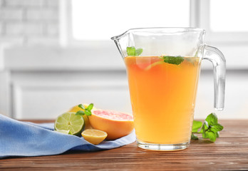 Fototapeta premium Tasty lemonade with mint in jug on table