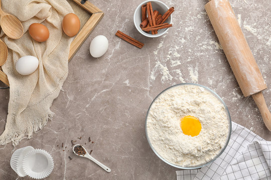 Composition with flour, eggs and spices on light background, top view