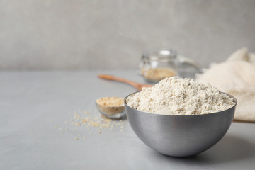 Bowl with sesame flour on table
