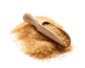 Wooden scoop with brown sugar on white background