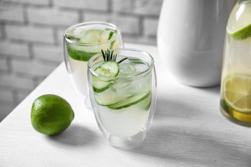 Glasses of fresh lemonade on table