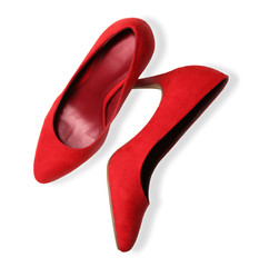 Pair of red female shoes on white background