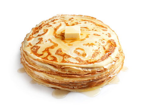 Stack of thin pancakes with butter on white background