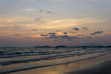 Fototapeta premium panorama landscape view of seascape and skyline with sun over the sea between the island and amazing twilight in the evening.