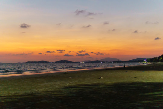 panorama landscape view of seascape and skyline with sun over the sea and reflection on the water surface at night.