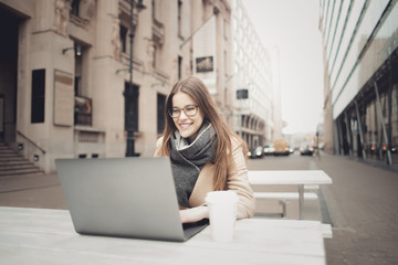 Smiling woman using a laptop