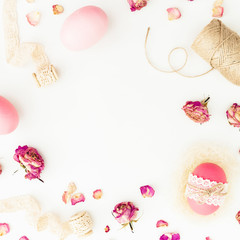 Easter pink eggs with twine, roses flowers and tapes on white background, Top view, Fat lay. Easter holiday