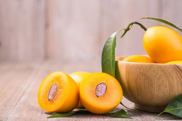 Fresh yellow marian plum fruit (Mayongchid in Thai name) on wooden table