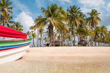 Beach palm trees and boat on caribbean island